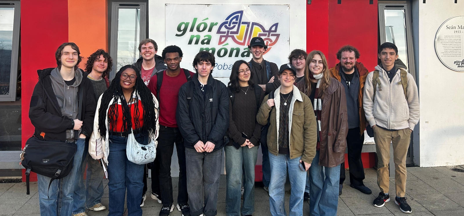 students standing in front of an irish language centre smiling
